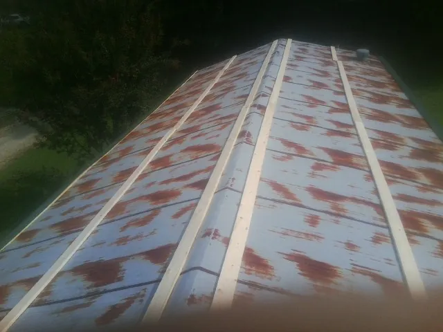 Rusted metal roof panels with new wood purlins before replacement — Storm Damage Roof Repair in Port Arthur by Roofing Brothers